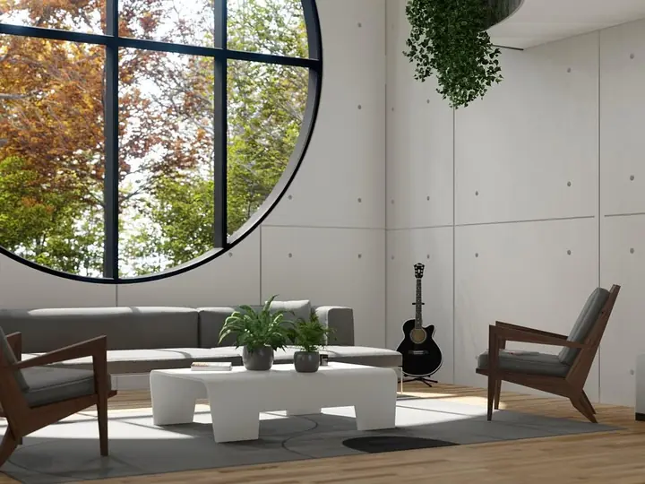 Phòng khách có sofa và cửa sổ tròn lớn nhìn ra vườn cây